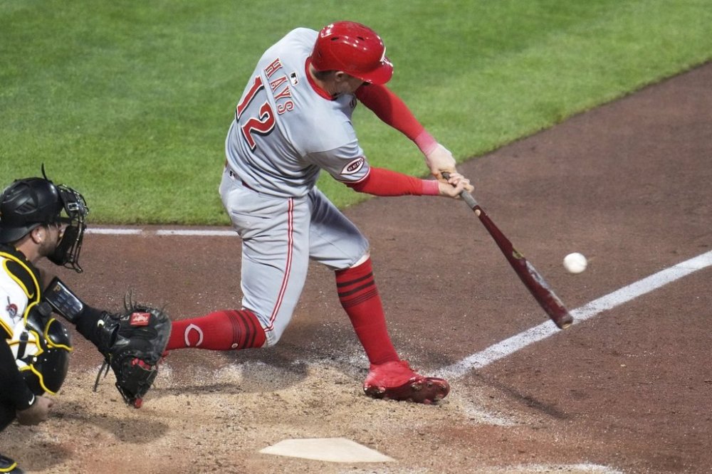 Cincinnati Reds' Austin Hays (12) singles off Pittsburgh Pirates pitcher David Bednar, driving in a run, during the eighth inning of a baseball game in Pittsburgh, Monday, May 19, 2025. (AP Photo/Gene J. Puskar)