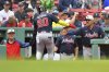 Atlanta Braves' Marcell Ozuna (20) is welcomed to the dugout after scoring on a bases-loaded walk in the fifth inning of a baseball game against the Boston Red Sox, Sunday, May 18, 2025, in Boston. (AP Photo/Steven Senne)