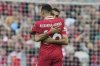 Liverpool's Mohamed Salah hugs teammate Trent Alexander-Arnold to celebrate after scoring his side's first goal during the English Premier League soccer match between Liverpool and Crystal Palace at the Anfield stadium in Liverpool, England, Sunday, May 25, 2025. (AP Photo/Jon Super)