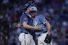Washington Nationals catcher Riley Adams, left, and pitcher Kyle Finnegan celebrate after winning a baseball game against the Texas Rangers at Nationals Park, Friday, June 6, 2025, in Washington. (AP Photo/Jess Rapfogel)