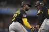 Pittsburgh Pirates' Andrew McCutchen, left, celebrates with first base coach Tarrik Brock, right, after hitting a home run during the fifth inning of a baseball game against the San Diego Padres, Saturday, May 31, 2025, in San Diego. (AP Photo/Gregory Bull)