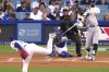 New York Yankees' Aaron Judge, right, hits a solo home run as Los Angeles Dodgers starting pitcher Tony Gonsolin, left, and catcher Will Smith watch during the first inning of a baseball game Friday, May 30, 2025, in Los Angeles. (AP Photo/Mark J. Terrill)