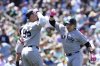 New York Yankees' Ben Rice, right, celebrates with Aaron Judge after hitting a grand slam during the fifth inning of a baseball game against the Athletics, Sunday, May 11, 2025, in West Sacramento, Calif. (AP Photo/Godofredo A. Vásquez)