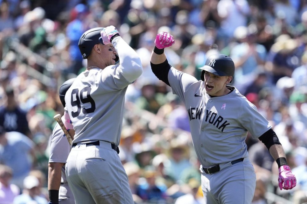 New York Yankees' Ben Rice, right, celebrates with Aaron Judge after hitting a grand slam during the fifth inning of a baseball game against the Athletics, Sunday, May 11, 2025, in West Sacramento, Calif. (AP Photo/Godofredo A. Vásquez)
