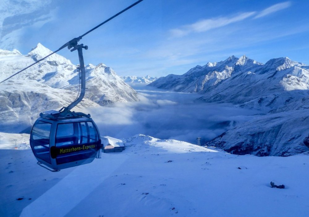 FILE - An empty gondola goes up in Zermatt, Switzerland, Dec. 3, 2020. (AP Photo/Jamey Keaten, File)