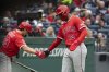 Los Angeles Angels' Scott Kingery, left, congratulates Jorge Soler (12) after Soler scored on a single by Jo Adell during the second inning of a baseball game against the Cleveland Guardians, Friday, May 30, 2025, in Cleveland. (AP Photo/Phil Long)