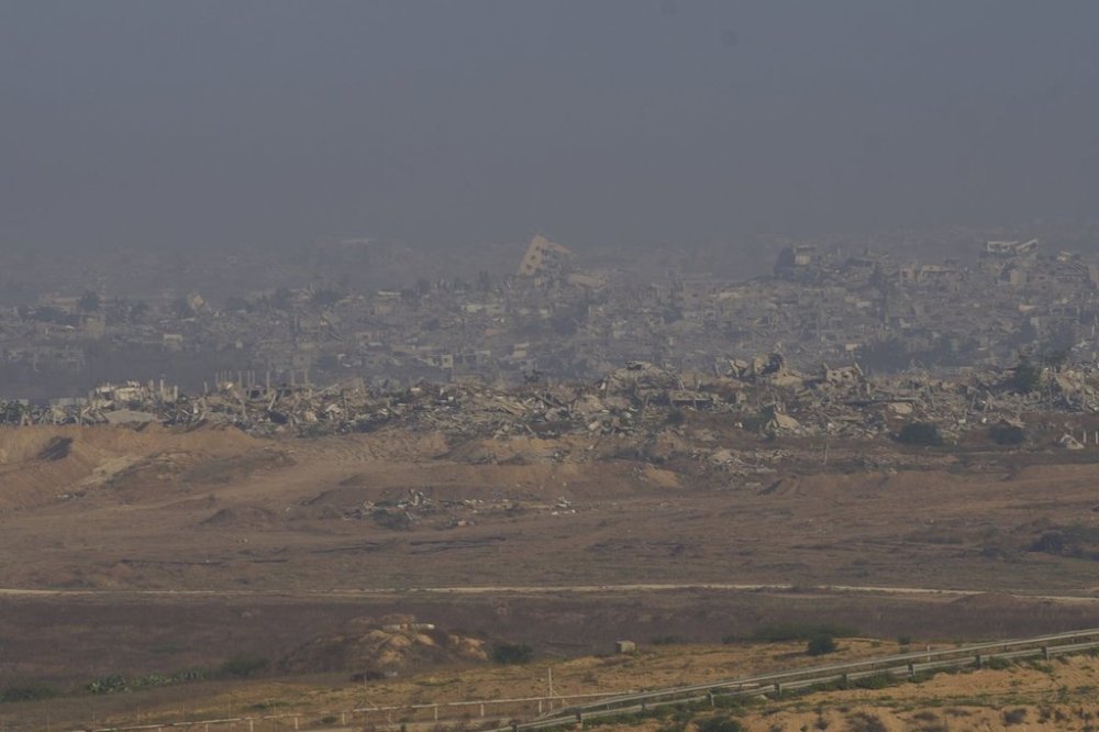 Destroyed buildings in the Gaza Strip are seen from southern Israel, Sunday, June 1, 2025. (AP Photo/Ohad Zwigenberg)