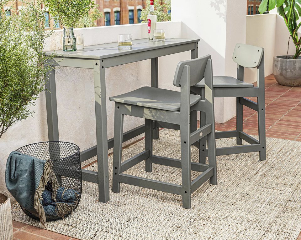 This image provided by Polywood shows their Studio Balcony Set. The slim profile, tuckable chairs and all-weather material makes it a good choice for city balconies or small patios. (Polywood via AP)