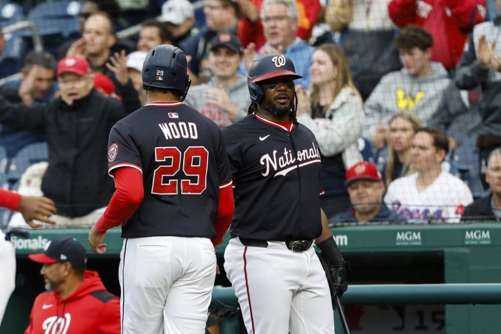 Washington Nationals' James Wood (29) is greeted by Josh Bell after scoring a run on a double hit by Keibert Ruiz against Atlanta Braves pitcher AJ Smith-Shawver during the first inning of a baseball game in Washington, Thursday, May 22, 2025. (AP Photo/Terrance Williams)