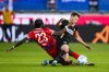 Heidenheim's Omar Traore, left, and Elversberg's Robin Fellhauer battle for the ball during a Bundesliga relegation playoff first leg soccer match between FC Heidenheim and SV Elversberg, Thursday, May 22, 2025, in Heidenheim, Germany. (Tom Weller/dpa via AP)