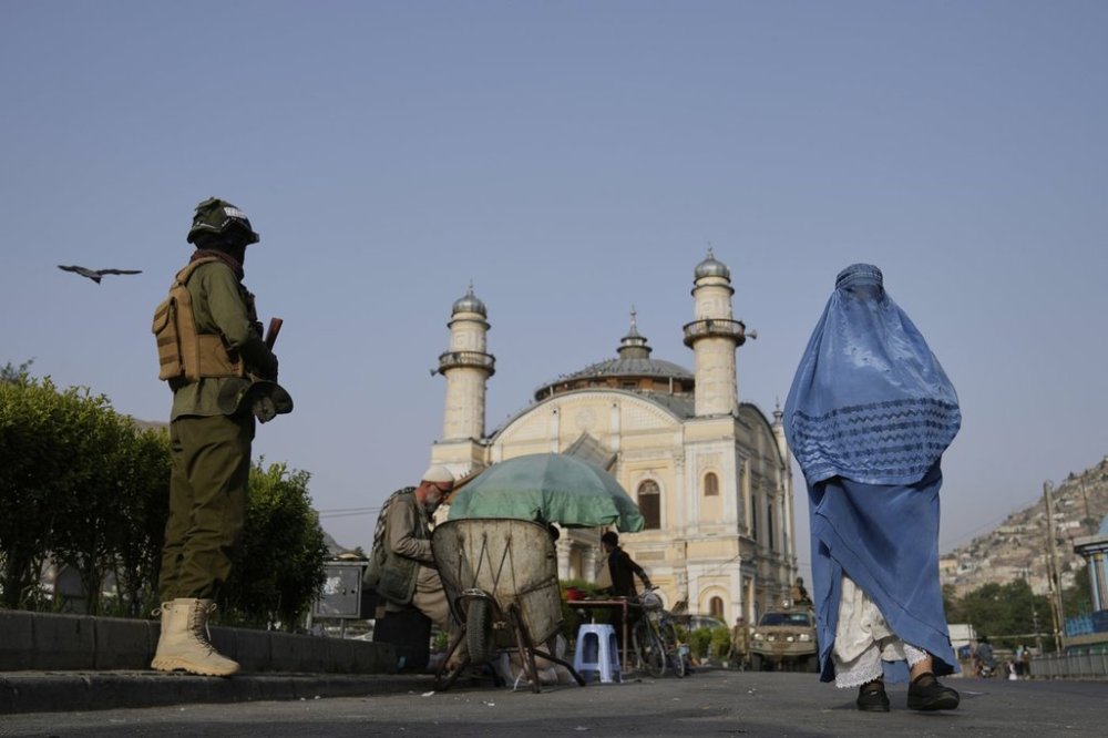 A Taliban fighter stands guard near the Shah-Do Shamshira Mosque as people attend the Eid al-Adha prayer in Kabul, Afghanistan, Saturday, June 7, 2025. (AP Photo/Ebrahim Noroozi)