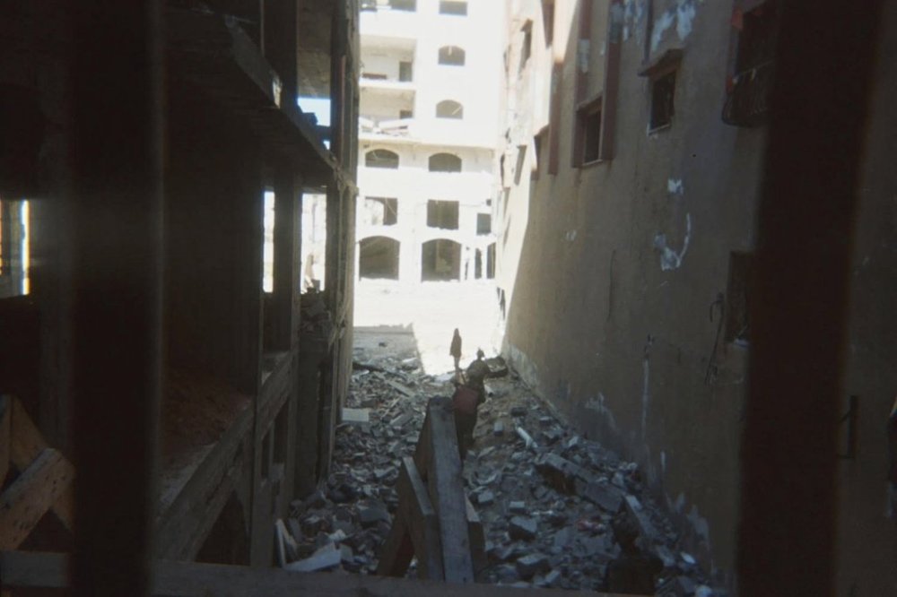 This photo provided by Breaking the Silence, a whistleblower group of former Israeli soldiers, shows two soldiers behind Palestinian detainees being sent into a Gaza City-area house to clear it in 2024. (Breaking the Silence via AP)