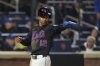 New York Mets' Francisco Lindor (12) gestures to Juan Soto as he scores on a single by Soto during the eighth inning of a baseball game against the Chicago Cubs Friday, May 9, 2025, in New York. (AP Photo/Frank Franklin II)