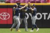 Milwaukee Brewers players, from left, Isaac Collins, Jackson Chourio and Sal Frelick celebrate in the outfield at the conclusion of a baseball game against the Milwaukee Brewers, Wednesday, June 4, 2025, in Cincinnati. (AP Photo/Kareem Elgazzar)