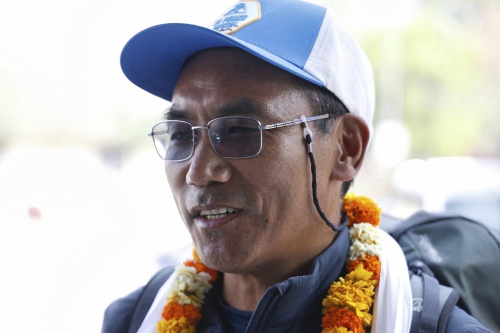 FILE - Renowned Sherpa mountain guide Kami Rita is garlanded at the Tribhuvan airport as he prepares to depart to ascend Mount Everest for the record 31st time, in Kathmandu, India, on April 20, 2025. (AP Photo/Gopen Rai, File)
