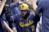 Milwaukee Brewers' Caleb Durbin celebrates in the dugout after scoring during the eighth inning of a baseball game against the Pittsburgh Pirates, Sunday, May 25, 2025, in Pittsburgh. (AP Photo/Matt Freed)