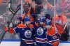 Oilers centre Leon Draisaitl, from left to right, defenceman Evan Bouchard and forward Ryan Nugent-Hopkins celebrate Draisaitl's overtime winner in Game 1 of the NHL Stanley Cup final against the Florida Panthers in Edmonton on Wednesday, June 4, 2025. THE CANADIAN PRESS/Darryl Dyck