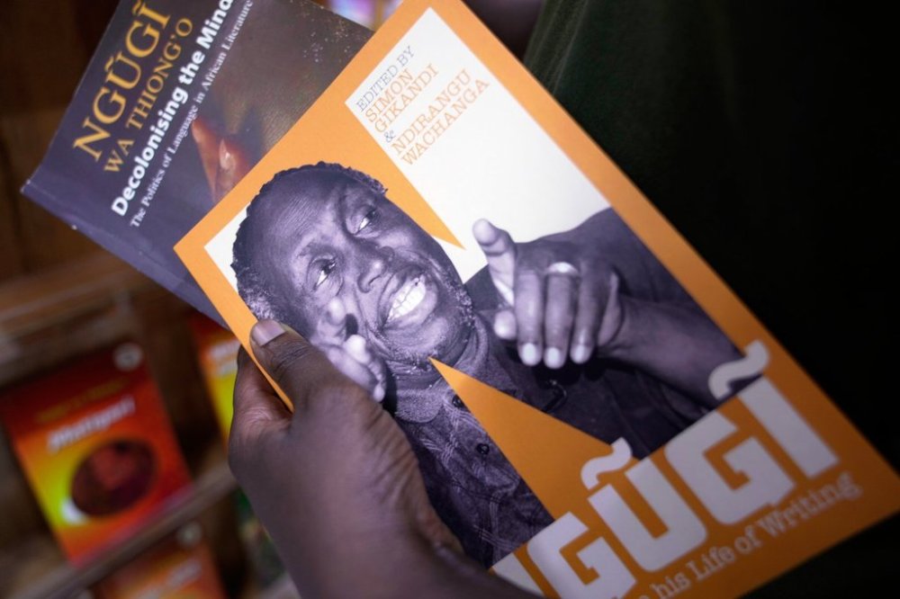 Bennet Mbata holds books of renowned Kenyan writer Ngugi wa Thiong'o, who died Wednesday in the U.S., at Nuria bookshop in Nairobi, Kenya, Thursday, May 29, 2025. (AP Photo/Brian Inganga)