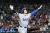 Los Angeles Dodgers' Shohei Ohtani celebrates a three run home run against for the Arizona Diamondbacks during the ninth inning of a baseball game Friday, May 9, 2025, in Phoenix. (AP Photo/Darryl Webb)