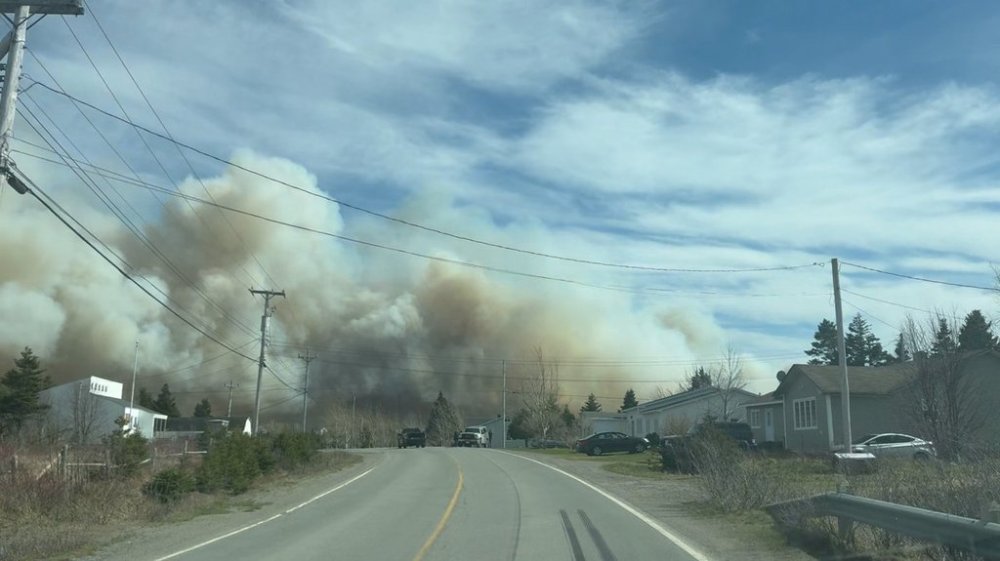 A wildfire burns close to homes near Western Bay, N.L., in this May 7 handout photo. THE CANADIAN PRESS/HO, Eugene Howell *MANDATORY CREDIT*