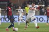 Genoa's Brooke Norton-Cuffy, left, plays the ball as Atalanta's Mateo Retegui defends during the Serie A soccer match between Genoa and Atalanta at the Luigi Ferraris Stadium in Genoa, Italy, Saturday, May 17, 2025. (Tano Pecoraro/LaPresse via AP)