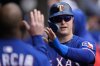 Texas Rangers designated hitter Joc Pederson (4) celebrates after scoring on a sacrifice fly from Marcus Semien (2) during the fourth inning of a baseball game against the Chicago White Sox, Saturday, May 24, 2025, in Chicago. (AP Photo/Erin Hooley)