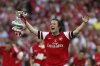 FILE - Arsenal's Tomas Rosicky celebrates with the trophy after their win against Hull City at the end of their English FA Cup final soccer match at Wembley Stadium in London, Saturday, May 17, 2014. (AP Photo/Sang Tan, File)