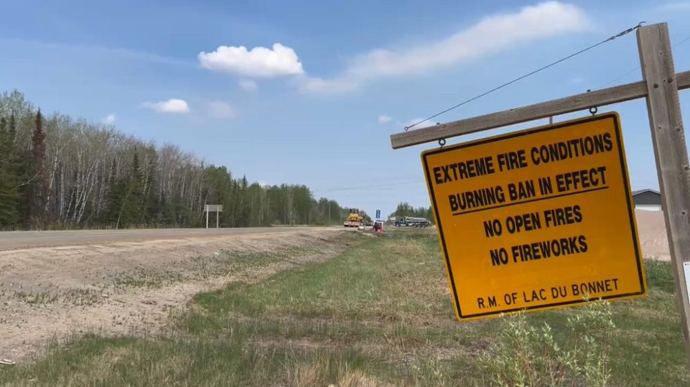 A burning ban warning sign is seen in the Rural Municipality of Lac du Bonnet, Man., on Thursday, May 15, 2025. Parts of Whiteshell Provincial Park that are a safe distance away from an out-of-control wildfire are set to reopen. THE CANADIAN PRESS/Steve Lambert