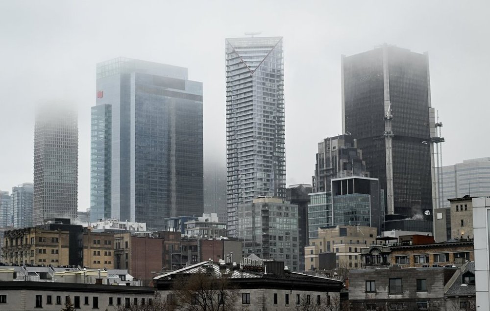 Fog hangs over the skyline of Montreal on Jan. 1, 2025. THE CANADIAN PRESS/Graham Hughes.
