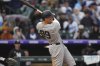 New York Yankees' Aaron Judge follows the flight of his RBI double off Colorado Rockies relief pitcher Jake Bird in the top of the fifth inning of a baseball game Sunday, May 25, 2025, in Denver. (AP Photo/David Zalubowski)