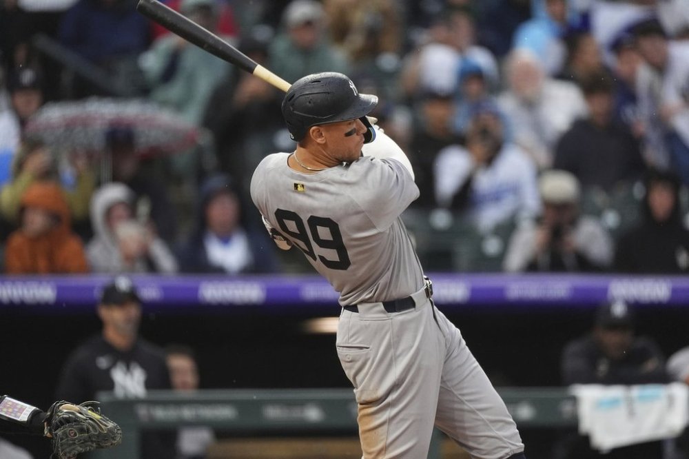New York Yankees' Aaron Judge follows the flight of his RBI double off Colorado Rockies relief pitcher Jake Bird in the top of the fifth inning of a baseball game Sunday, May 25, 2025, in Denver. (AP Photo/David Zalubowski)