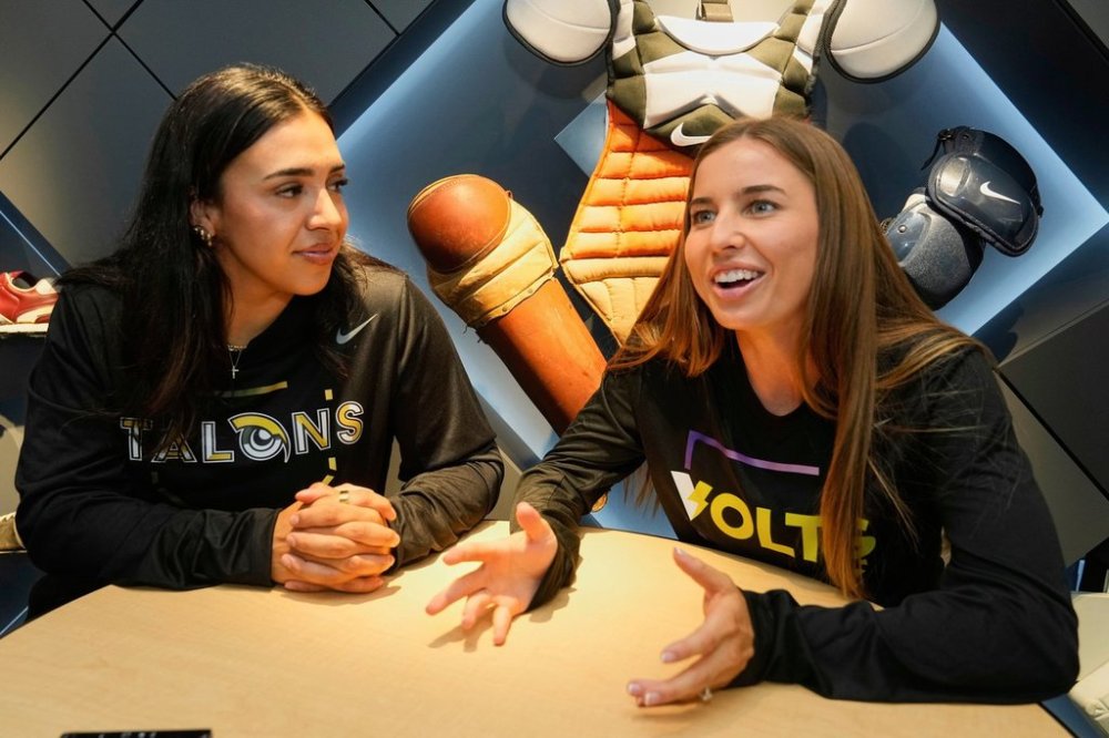 Athletes Unlimited Softball League players Charlie Palacios, left, of the Talons, and Sis Bates of the Bolts, are interviewed at Major League Baseball's headquarters in New York, Thursday, May 29, 2025. (AP Photo/Richard Drew)