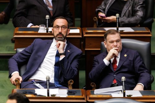 Minister of Colleges, Universities, Research Excellence and Security Nolan Quinn, left, and Environment, Conservation and Parks Minister Todd McCarthy sit in the Ontario legislature at Queen's Park in Toronto, Monday, April 14, 2025. THE CANADIAN PRESS/Cole Burston