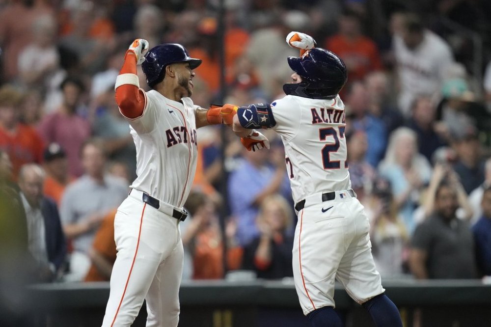 Houston Astros' Jose Altuve (27) celebrates his two-run home run with Jeremy Peña, left, against the Athletics during the fourth inning of a baseball game, Tuesday, May 27, 2025, in Houston. (AP Photo/Karen Warren)