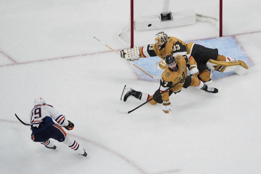 Edmonton Oilers center Leon Draisaitl (29) scores against Vegas Golden Knights goaltender Adin Hill (33) during overtime of Game 2 of a second-round NHL hockey playoff series, in Las Vegas, Thursday, May 8, 2025. THE CANADIAN PRESS/AP-John Locher