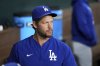 Los Angeles Dodgers starting pitcher Clayton Kershaw, who is on the 60-day injured list with a left toe injury, looks on from the dugout before a baseball game against the Texas Rangers, Saturday, April 19, 2025, in Arlington, Texas. (AP Photo/Jeffrey McWhorter)