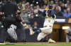 Milwaukee Brewers' Rhys Hoskins (12) slides into home to score during the second inning of a baseball game against the Baltimore Orioles, Monday, May 19, 2025, in Milwaukee. (AP Photo/Aaron Gash)