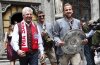 Bayern's Harry Kane, right, arrives with the Championship trophy together with teammate Thomas Mueller, center, and Dieter Reiter (SPD), Lord Mayor of Munich, at the championship celebration in the city hall in Munich, Germany, Sunday, May 18, 2025. (Daniel Loeb/dpa via AP)