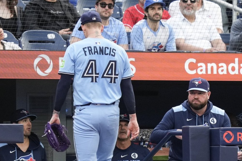 Blue Jays manager John Schneider watches pitcher Bowden Francis (44) walk back to the dugout after giving up six runs to the Philadelphia Phillies in the first inning of a Major League Baseball game in Toronto on Tuesday, June 3, 2025. THE CANADIAN PRESS/Chris Young