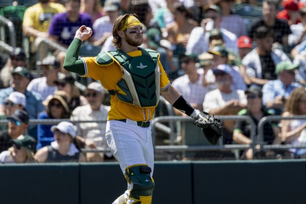 Athletics catcher Willie MacIver throws the ball to the pitcher during the fifth inning of a baseball game against the Philadelphia Phillies, Sunday, May 25, 2025, in West Sacramento, Calif. (AP Photo/Sara Nevis)