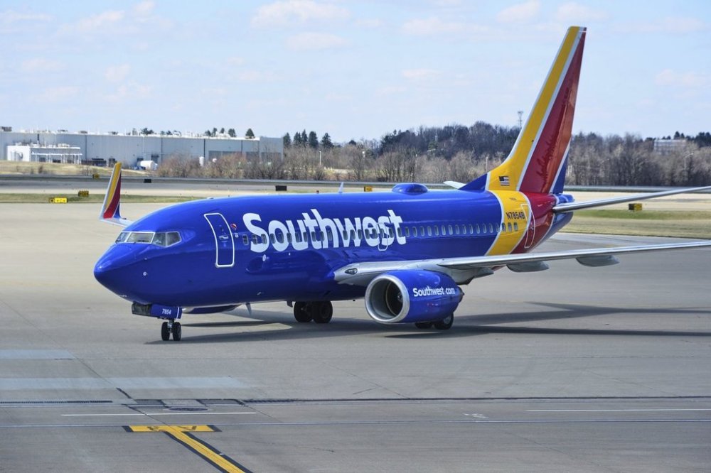 FILE - A Southwest Airlines plane pull into a gate at Pittsburgh International Airport in Imperial, Pa., Thursday, March 27, 2025. (AP Photo/Gene J. Puskar, File)