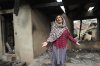 Rubina Begum wails as she stands outside her house damaged by Pakistani artillery shelling, at Salamabad village in Uri ,north of Srinagar, Indian controlled Kashmir, Thursday, May 8, 2025. (AP Photo/Mukhtar Khan)