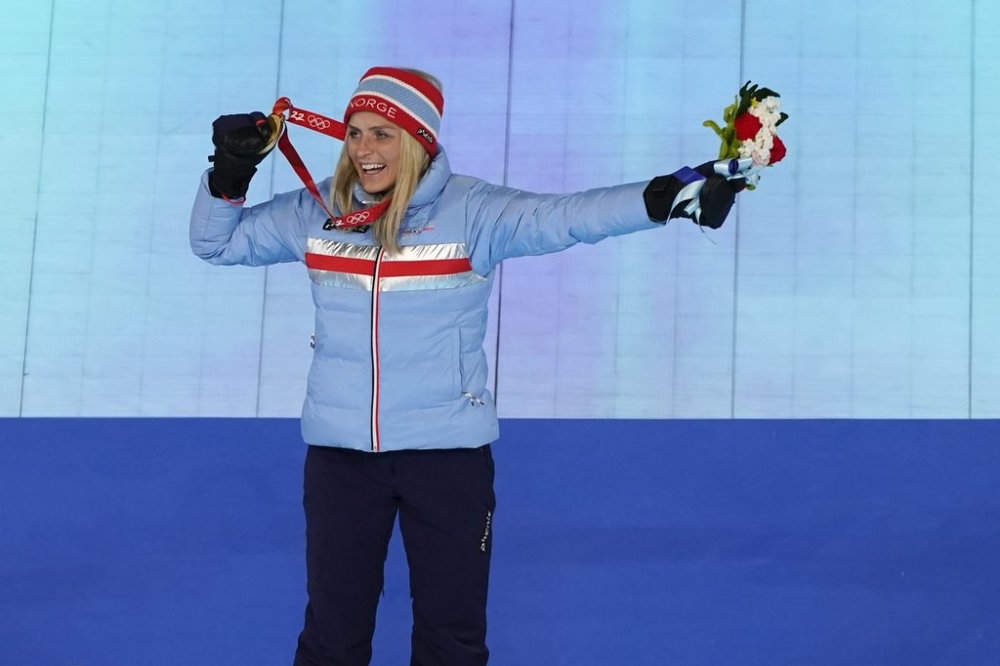 FILE - Gold medalist Therese Johaug, of Norway, poses during the medal ceremony for the women's 30km mass start free cross-country skiing at the closing ceremony of the 2022 Winter Olympics, Feb. 20, 2022, in Beijing. (AP Photo/Brynn Anderson, File)