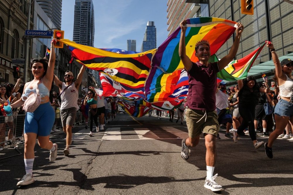 The Toronto Pride Parade will wind through the streets of the Ontario capital, with thousands expected to attend. Participants run with a multinations pride flag during the Toronto Pride Parade, Sunday, June 25, 2023. THE CANADIAN PRESS/Chris Young