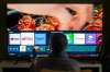 A person browses a television menu showing icons for streaming services Netflix and Amazon Prime in a photo illustration made in Toronto on Friday, March 22, 2024. THE CANADIAN PRESS/Giordano Ciampini