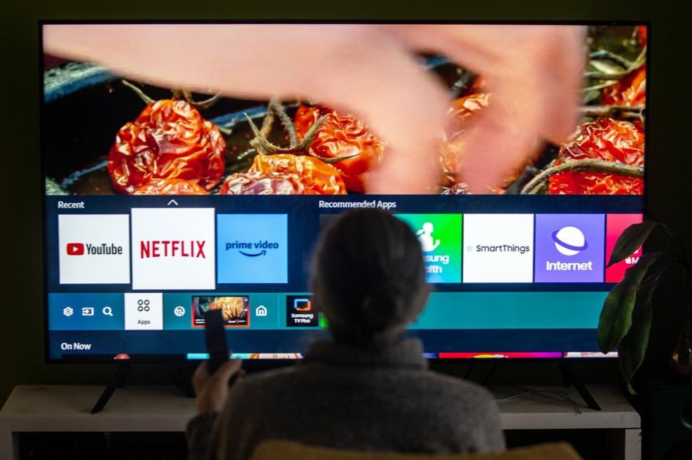 A person browses a television menu showing icons for streaming services Netflix and Amazon Prime in a photo illustration made in Toronto on Friday, March 22, 2024. THE CANADIAN PRESS/Giordano Ciampini