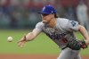Los Angeles Dodgers first baseman Kike Hernandez tosses the ball to the pitcher at first to get the out on Kansas City Royals' Jac Caglianone during the fourth inning of a baseball game Sunday, June 29, 2025, in Kansas City, Mo. (AP Photo/Charlie Riedel)