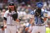 Atlanta Braves pitcher Grant Holmes (66) speaks with catcher Sean Murphy (12) in the sixth inning of a baseball game against the Colorado Rockies, Sunday, June 15, 2025, in Atlanta. (AP Photo/Mike Stewart)