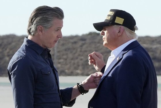 President Donald Trump talks with California Gov. Gavin Newsom after arriving on Air Force One at Los Angeles International Airport in January. (Mark Schiefelbein / The Associated Press files)