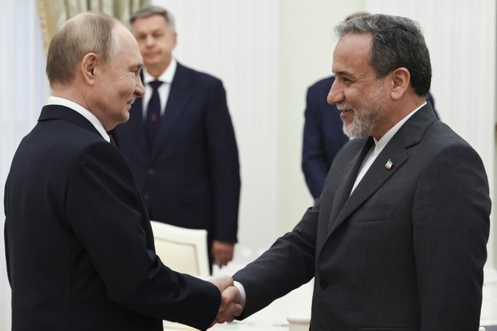 Russian President Vladimir Putin, left, greets Iranian Foreign Minister Abbas Araghchi prior to their talks at the Kremlin in Moscow, Russia, Monday, June 23, 2025. (Alexander Kazakov, Sputnik, Kremlin Pool Photo via AP)